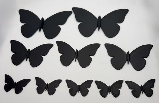 Three sizes of 3D printed butterfly wall decorations laid flat