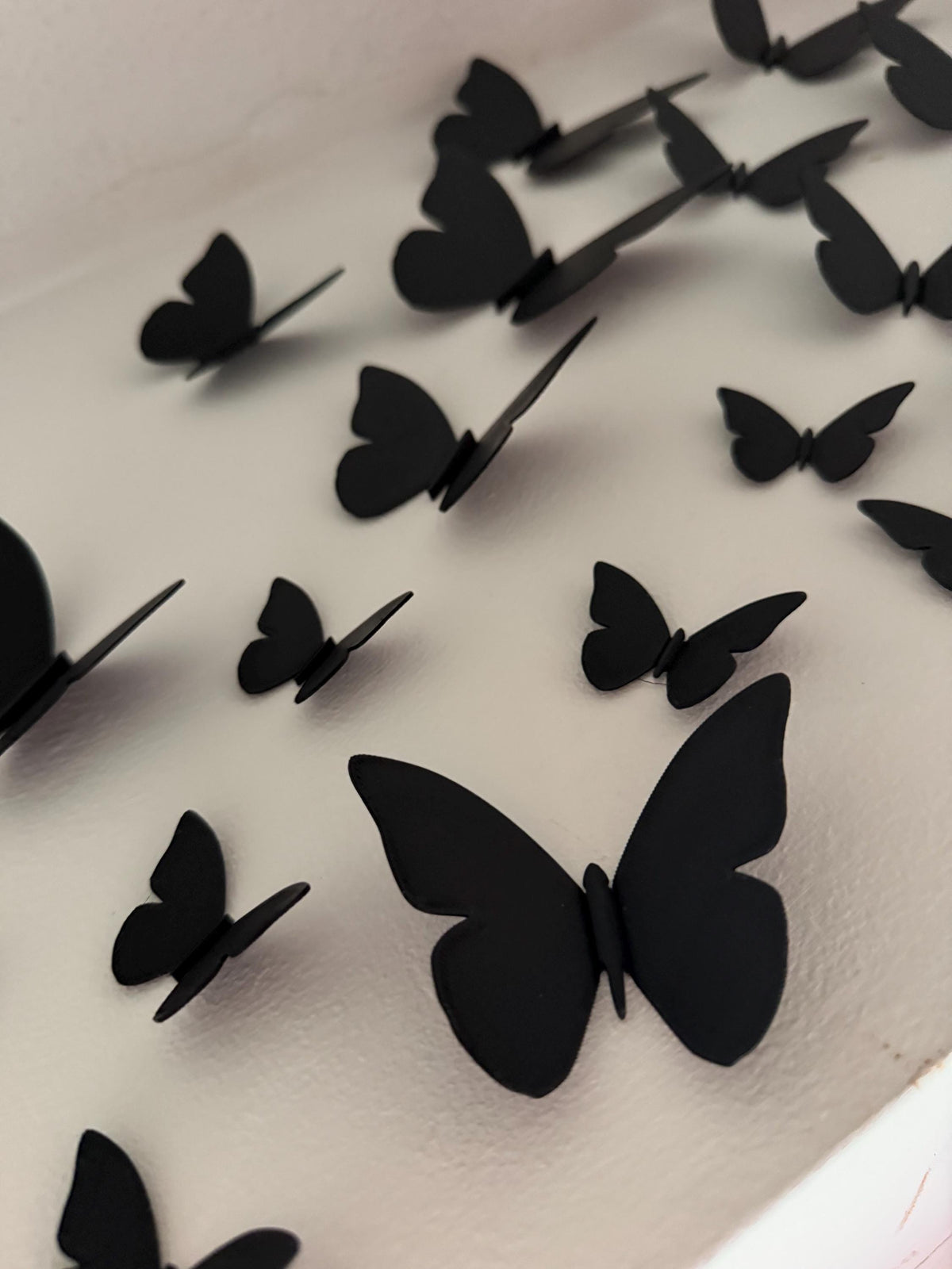 Close-up of a large 3D printed butterfly with wings projecting from the wall