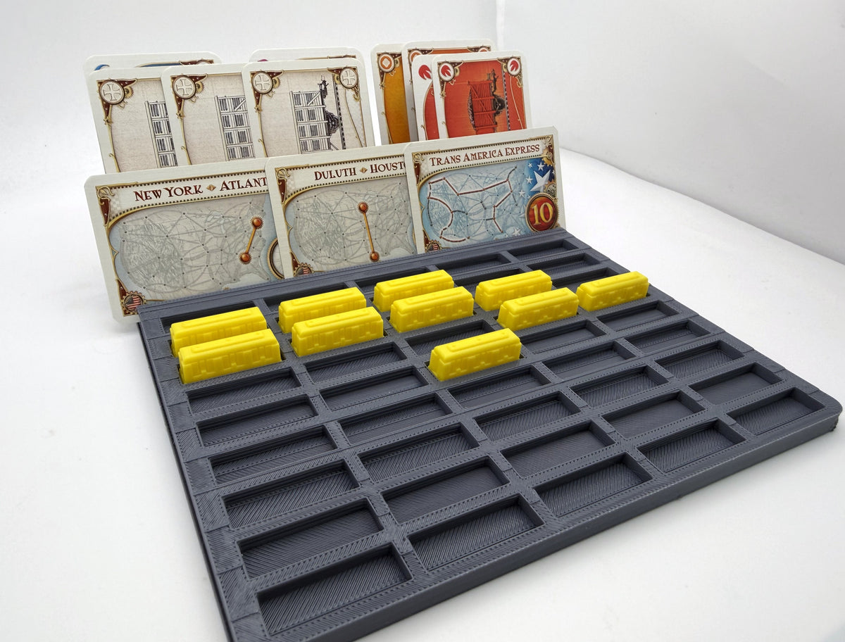 Player tray with individual train slots at an angle, with yellow train pieces and cards - compatible with Ticket to Ride