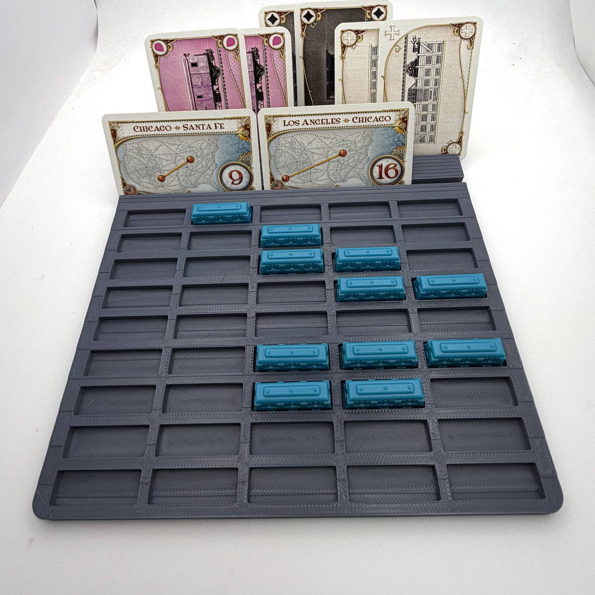 Player tray with individual train slots holding blue train pieces, cards standing behind - compatible with Ticket to Ride