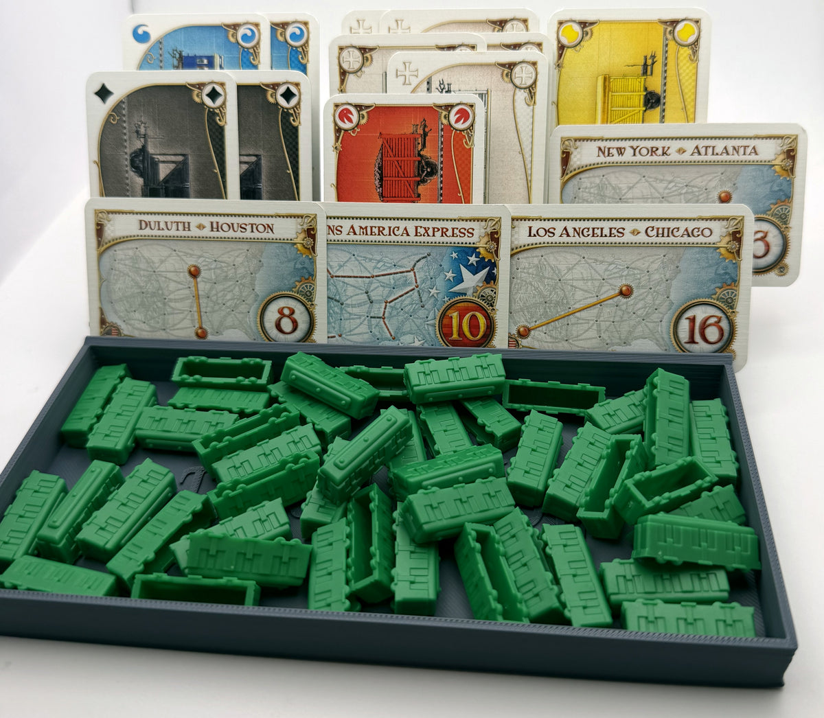 Grey open player tray filled with green train pieces, cards standing in the 6 angled rear channels - compatible with Ticket to Ride