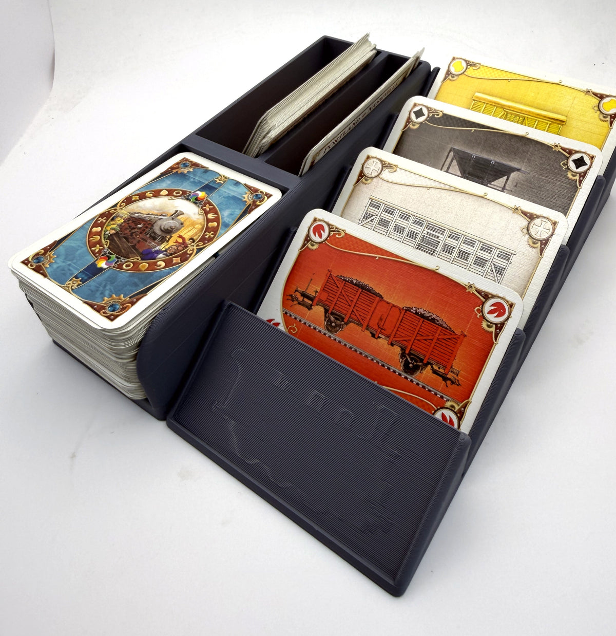 Small card organiser in grey, loaded, with the front display slot empty to show the engraved train plate - compatible with Ticket to Ride