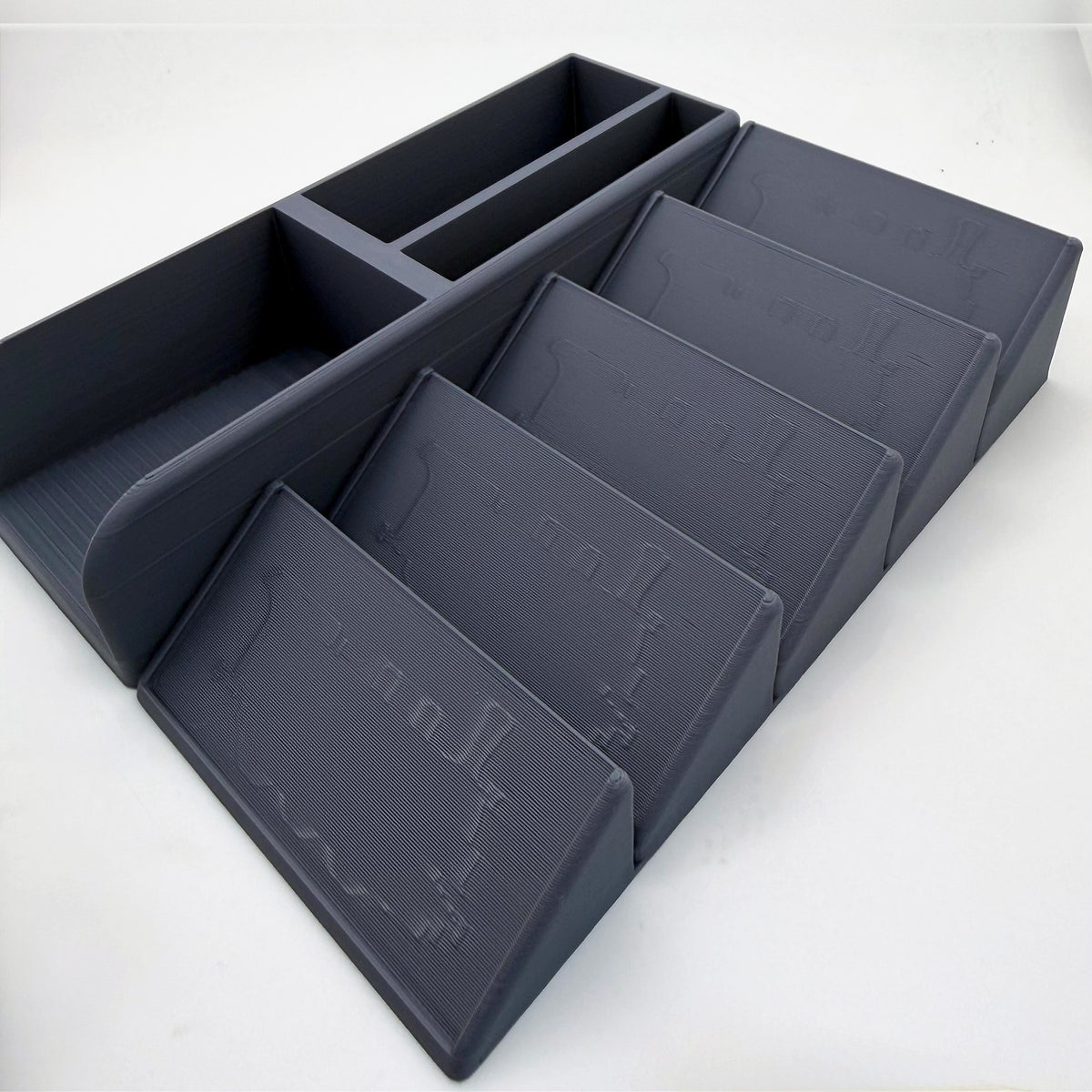 Empty grey card organiser, low side view of the stepped display slots with engraved train plates - compatible with Ticket to Ride