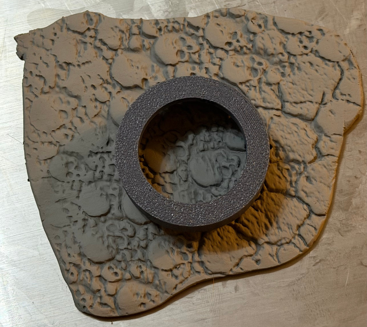 Round base cutter on skull textured modelling clay