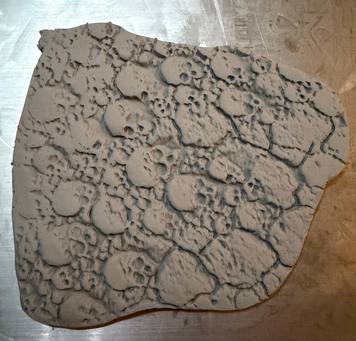 Modelling clay textured with Skull Paving roller