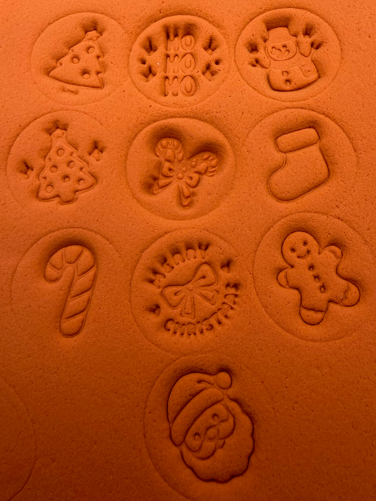 Christmas stamp impressions in orange clay