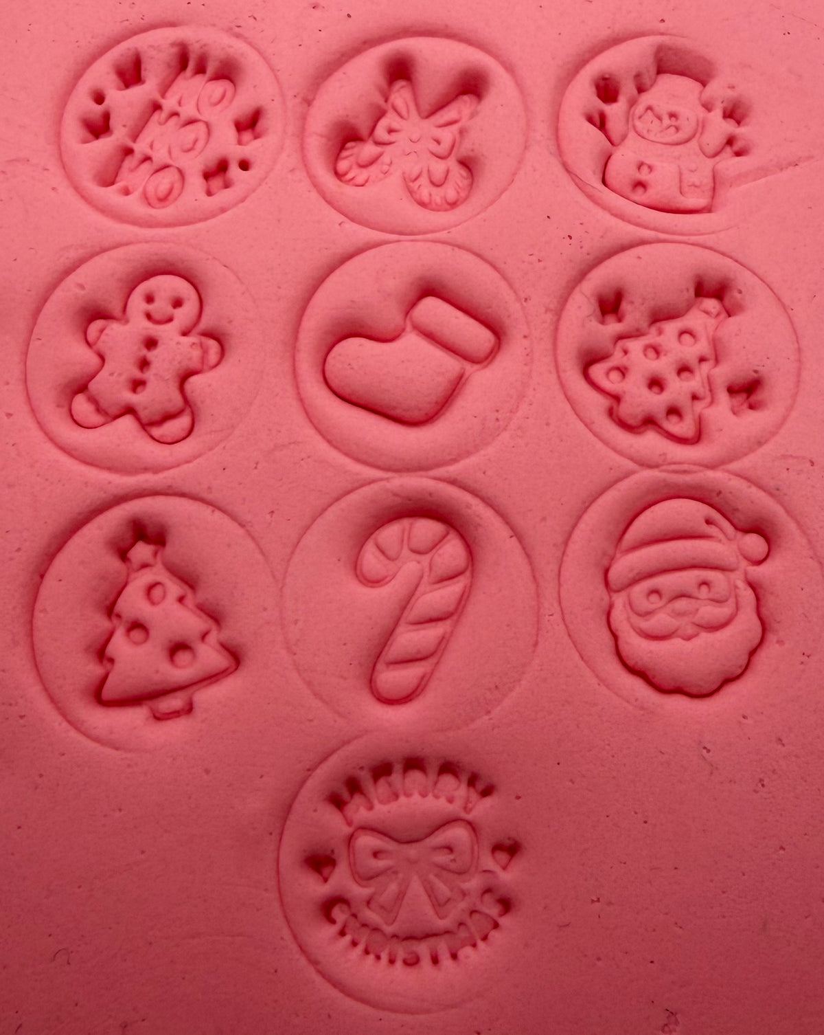 Christmas stamp impressions in pink clay