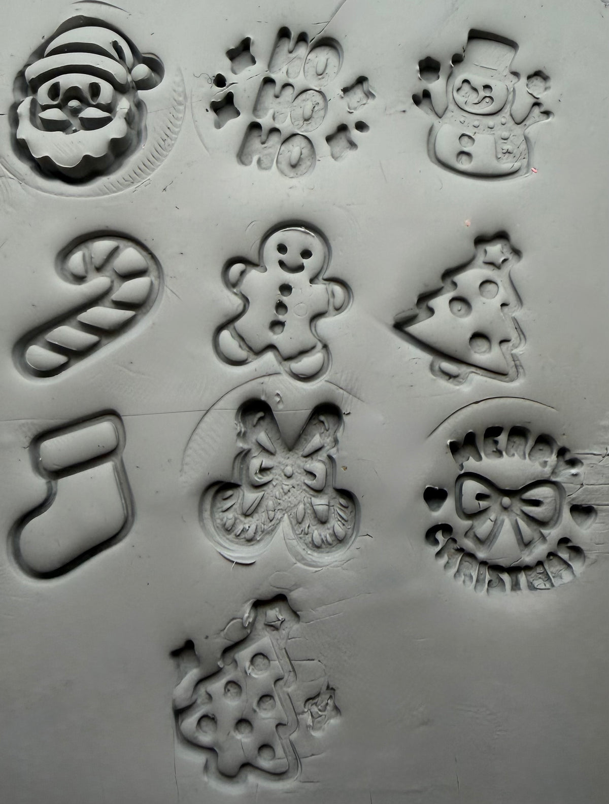 Christmas stamp impressions in grey clay
