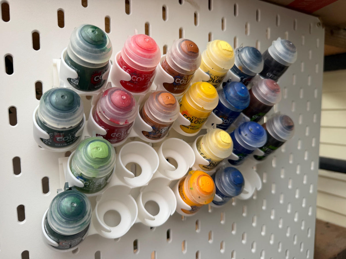 White staggered Citadel paint pot holders for IKEA SKÅDIS - workshop board view