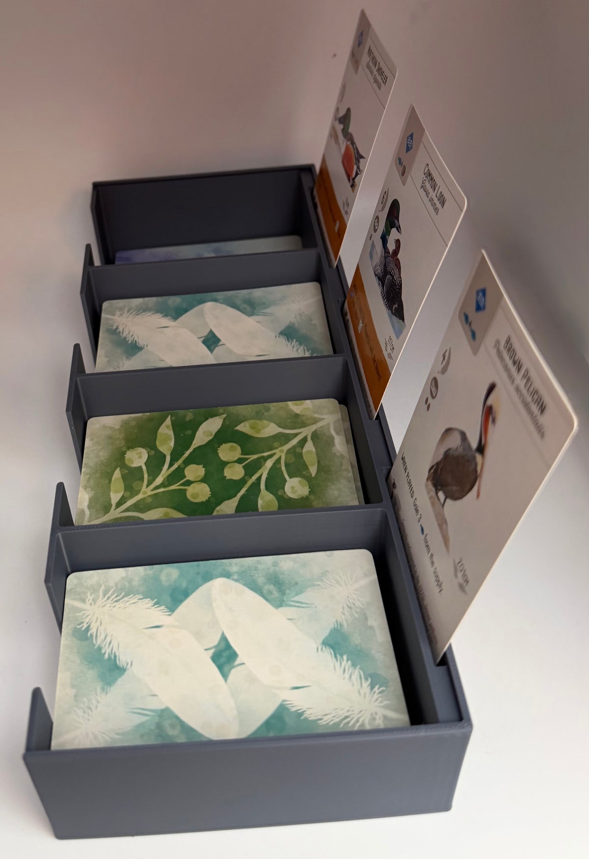 Complete three-piece organiser bundle compatible with Wingspan: central card bank, rotating egg and token organiser and birdhouse-style dice tower with tray, 3D printed in PLA+