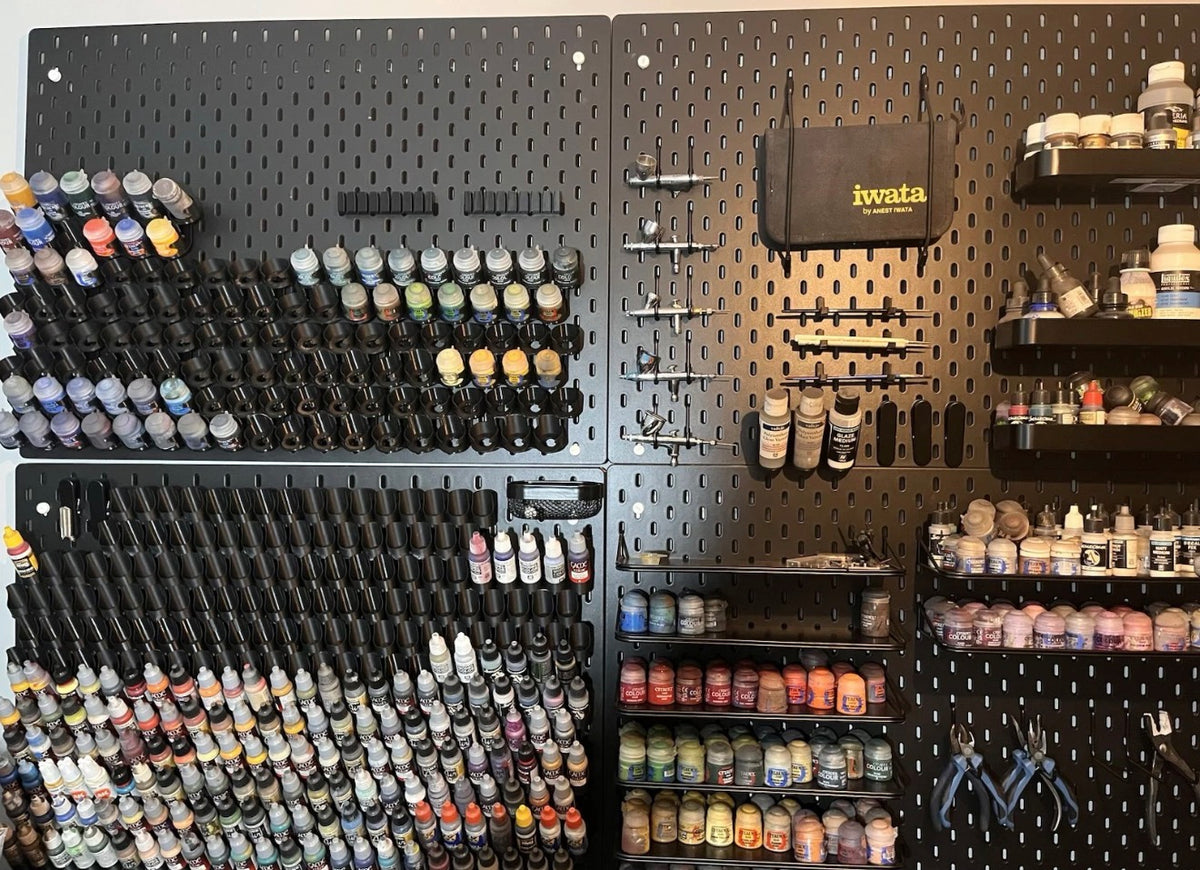Customer SKÅDIS pegboard wall with dropper bottle paint holders in use