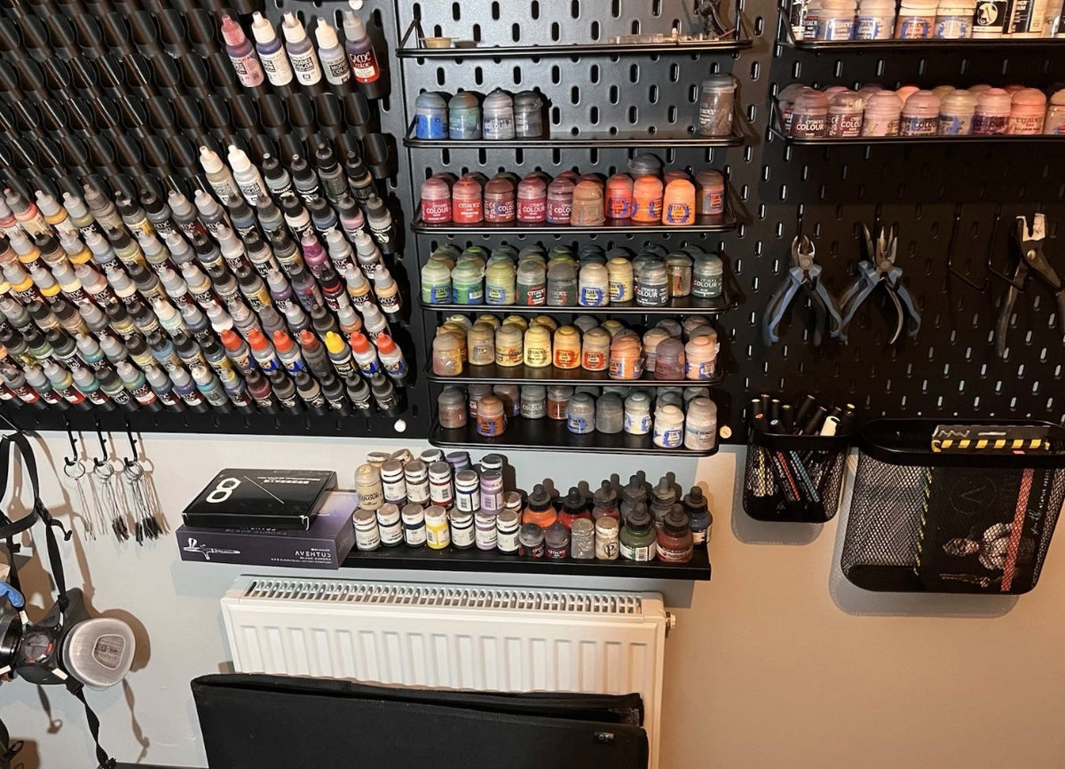 Customer SKÅDIS paint wall with dropper bottle holders and shelves