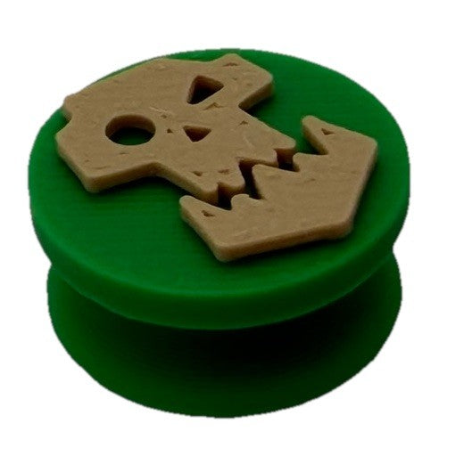 Green orc skull shoe charm, angled view showing the raised skull