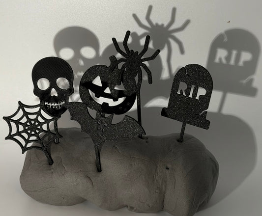 Six black Halloween cake toppers: skull, spider web, pumpkin, bat, spider and RIP gravestone