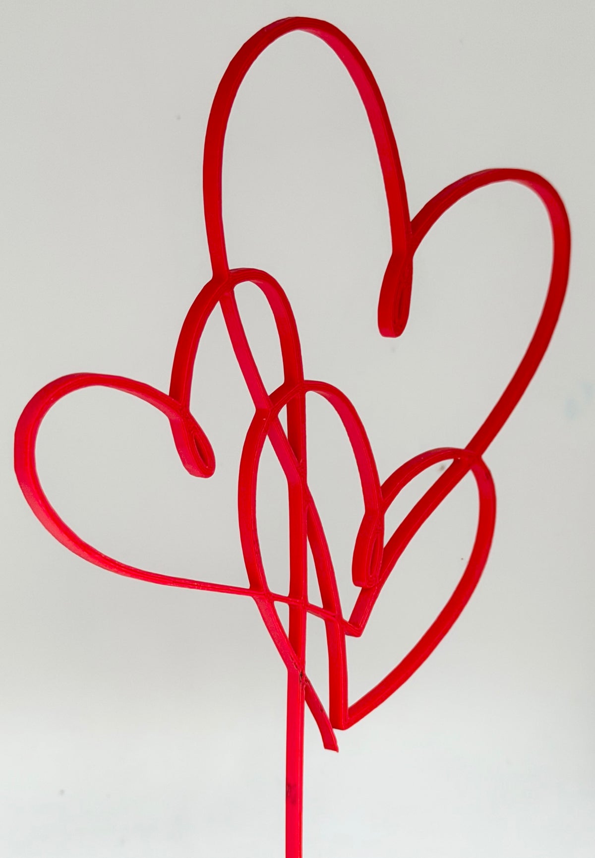 Red intertwined hearts cake topper