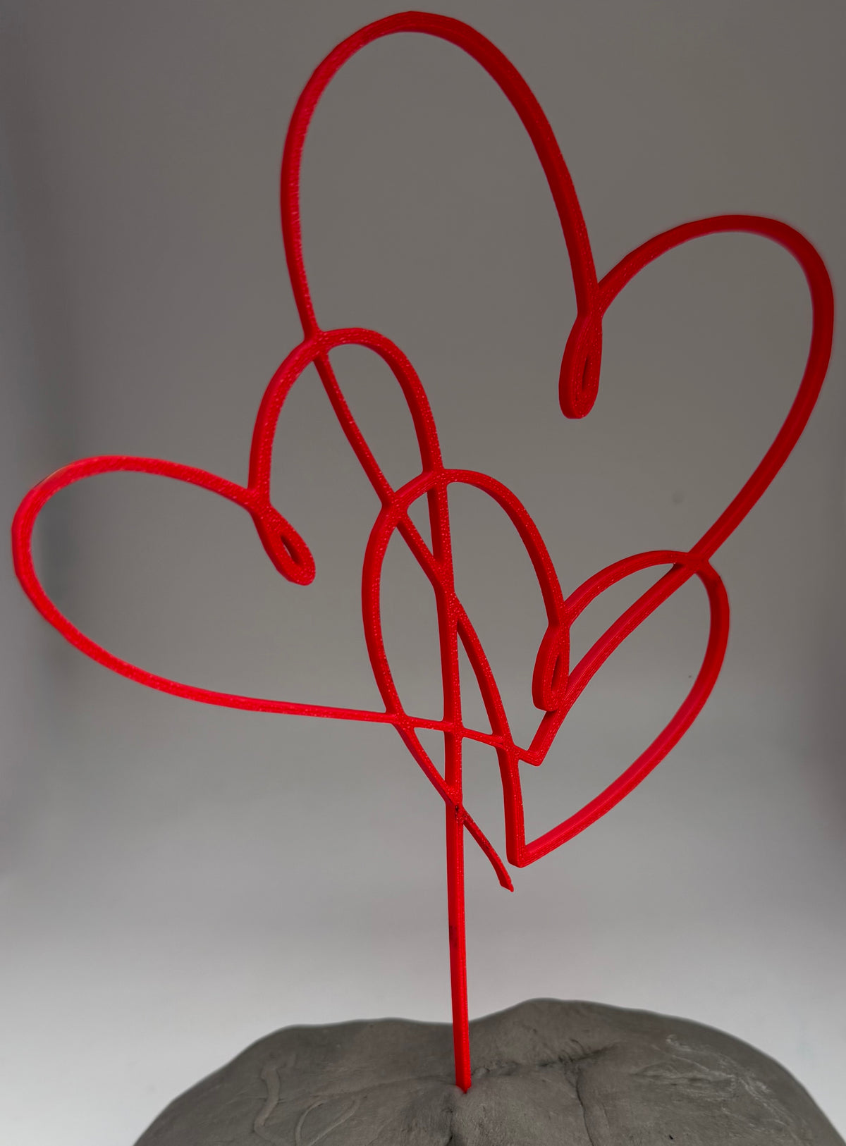 Red three heart cake topper on a pick