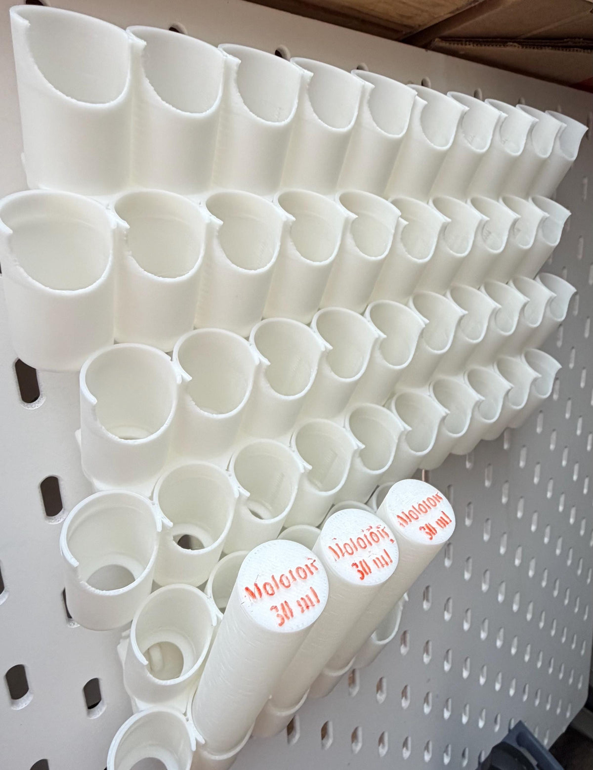 Black Molotow 30 ml paint bottle holders on IKEA SKÅDIS pegboard