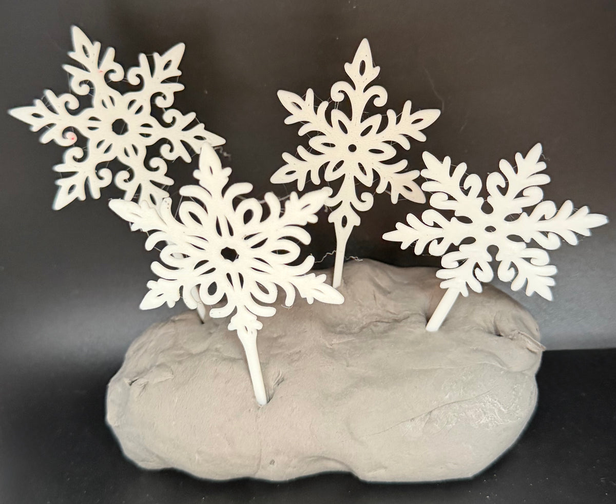 White filigree snowflake cake topper detail