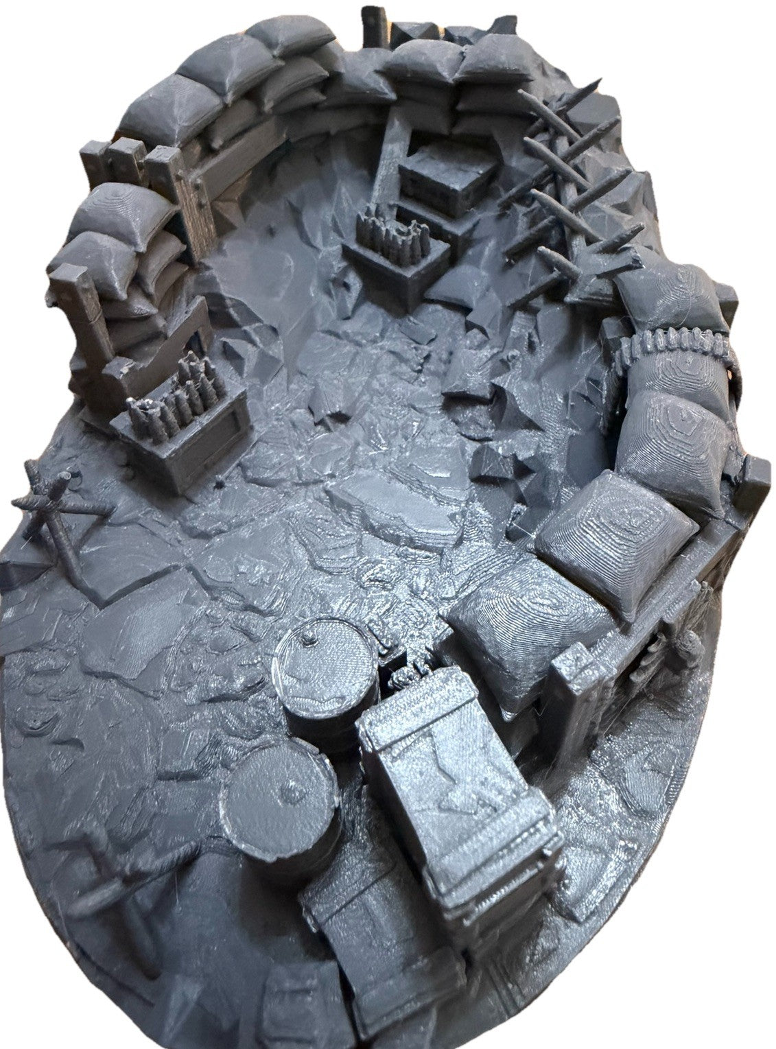 Unpainted trench warfare base showing crates, barrels and sandbag wall